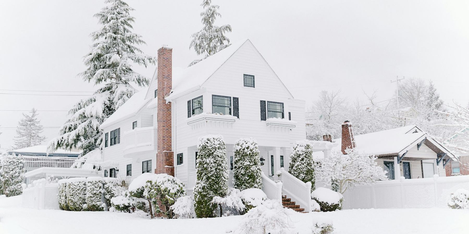 Snow-blanketed American home after the season’s first storm — FrostList pins every winter-prep deadline to your city’s NOAA freeze data