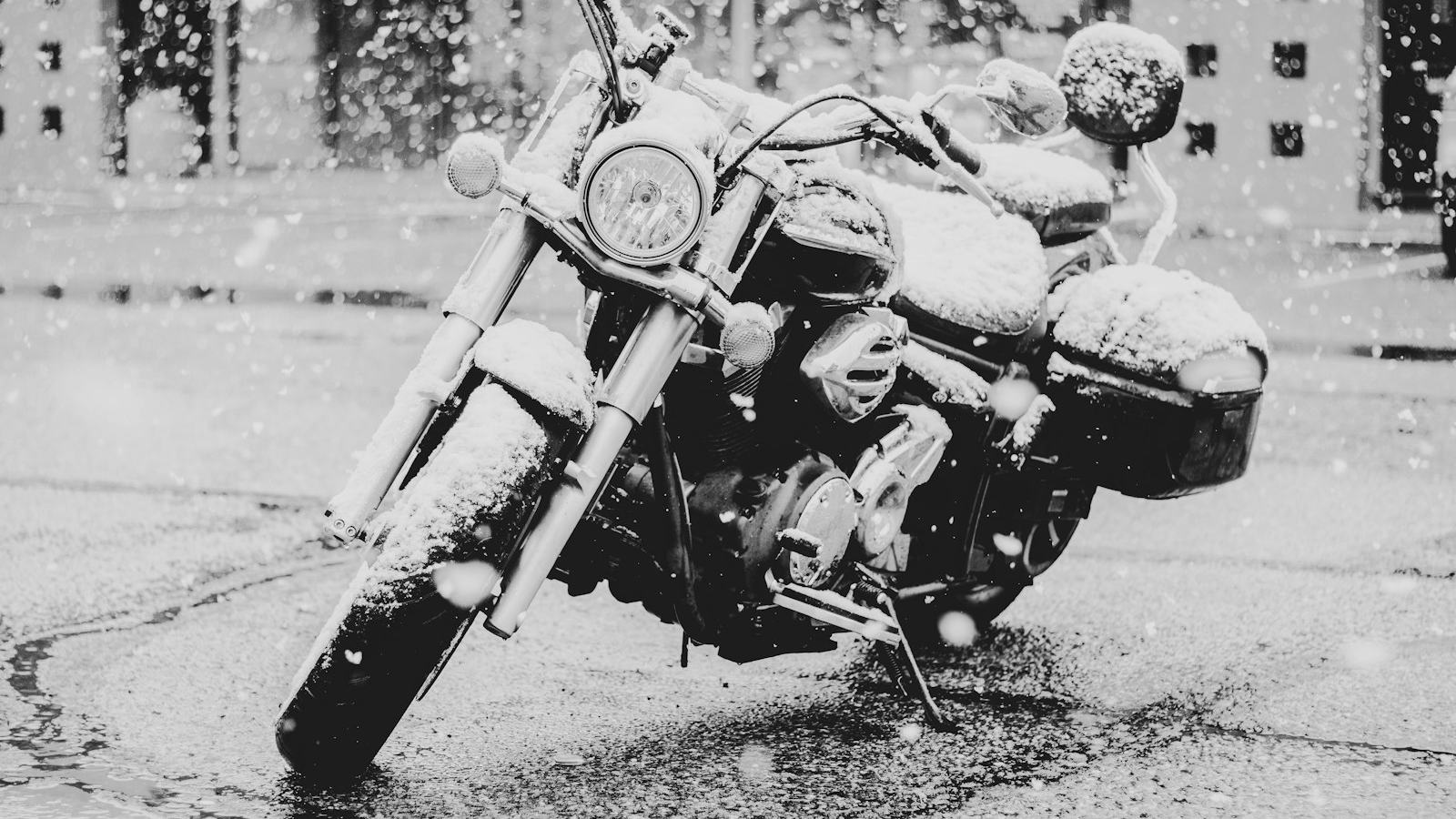 Touring motorcycle caught outside under a blanket of snow — put the bike into proper storage before riding season closes
